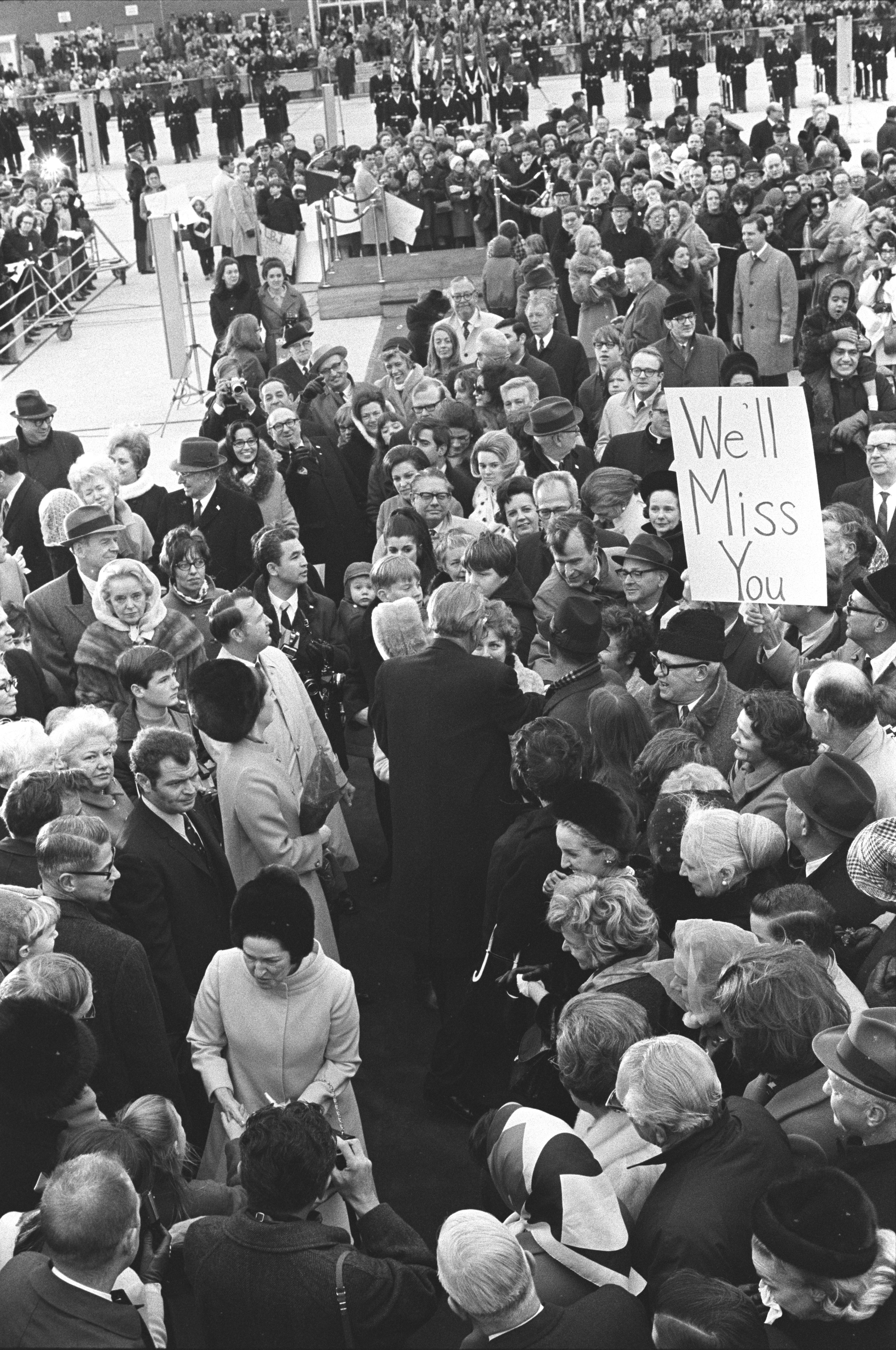 President Johnson and Congressman Bush shake hands in a crowd.